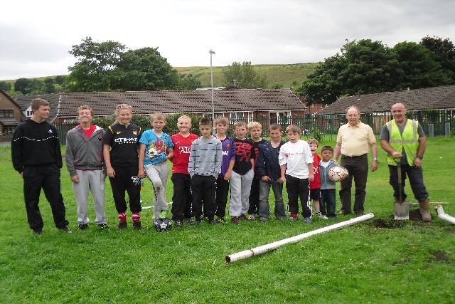 Councillor Keith Swift and local children alongside the new goalposts