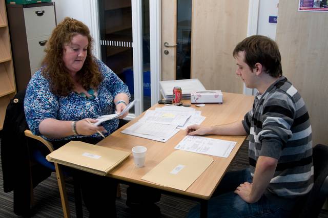 Director of Sixth Form Studies at St. Ann's Academy, Rebecca Laming assists student Steven Miles with his A Level results