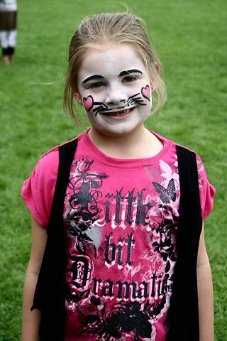 Young girl showing off her painted face