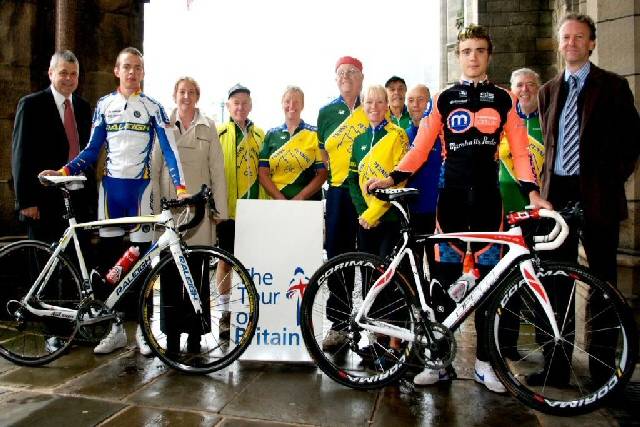 Cyclists Steven Burke (front left) and Richard Handley (front right) with organisers and local cyclists help to launch Stage One of the Tour of Britain at the town hall