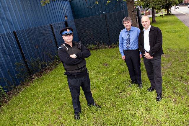 PCSO Martyn Beever from Rochdale South Neighbourhood Policing Team with Gary Davies, Project Officer for Rochdale Development Agency and store owner John Droogan at the site near Oldham Road