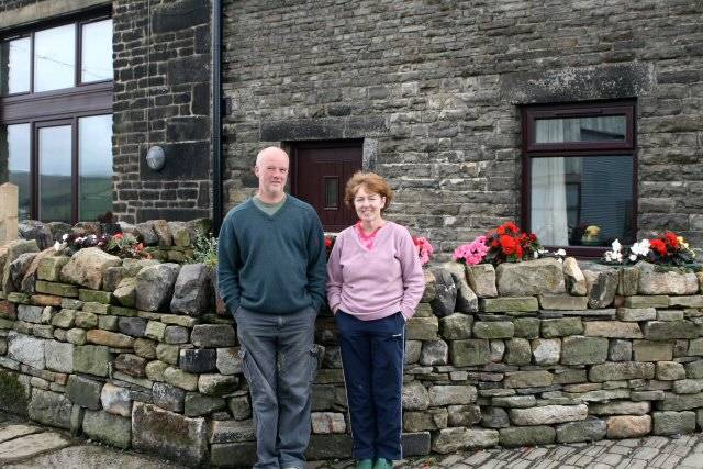 Norman and Jean Molyneux outside the cottages at Fielden Farm