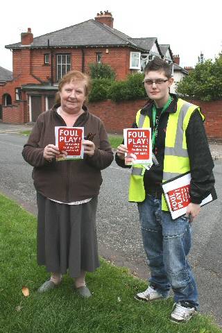 Heywood resident Jean Gray is handed a Foul Play red card from Natalie Williams (working on behalf of the council)