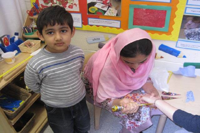 One visitor having mendhi decorations applied
