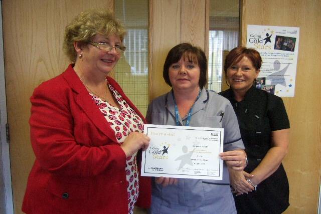 Suzanne Allison receives her award from Non-Executive Diane Hardwick, along with nominator Gillian Tandy 
 
