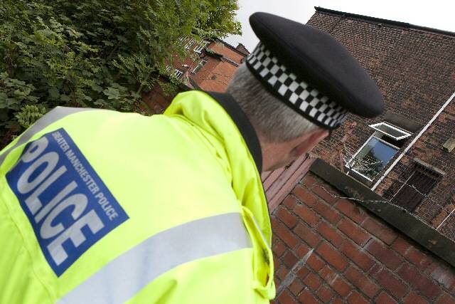 Chief Superintendent John O'Hare looking at an open window