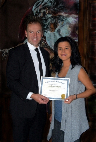 Caroline Abrahams receiving a certificate of achievement from Greg Couzens 
