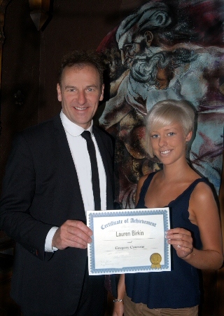 Lauren Birkin receiving a certificate of achievement from Greg Couzens 