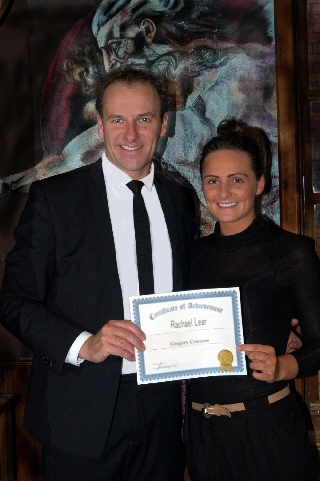 Rachael Lear receiving a certificate of achievement from Greg Couzens 