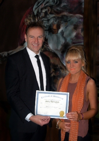 Jenny Warrington receiving a certificate of achievement from Greg Couzens 