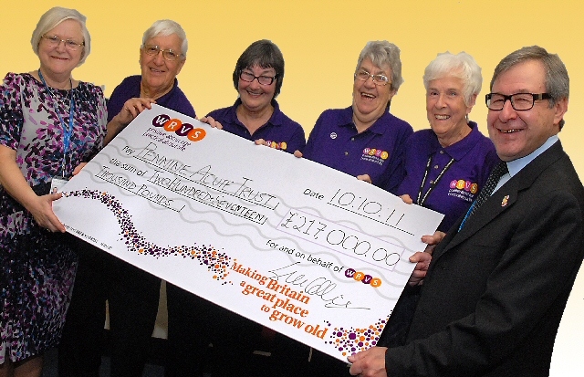 John Jesky, Chairman of The Pennine Acute Trust, accepting the check from WRVS