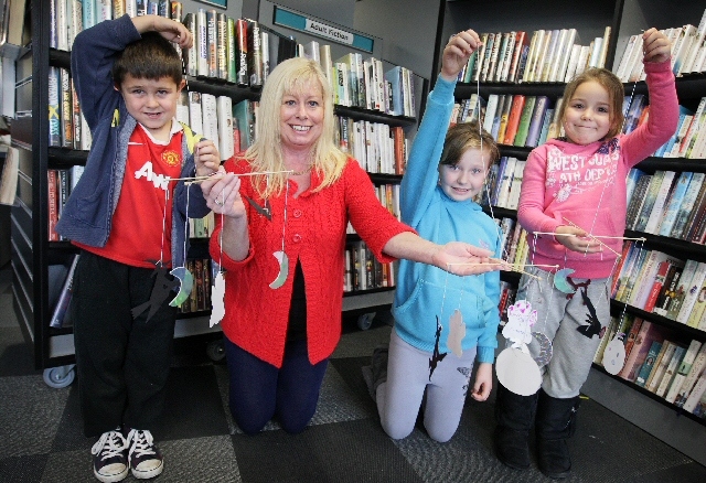 Guinness Northern Counties Housing Manager, Leila Poricka with Billy Corns, Mia Brooks, Kiera Carroll and the spooky mobiles they made.