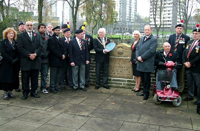 Dignitaries standing by the newly restored Lancashire Fusiliers wall overlooking the memorial fountain currently being restored.