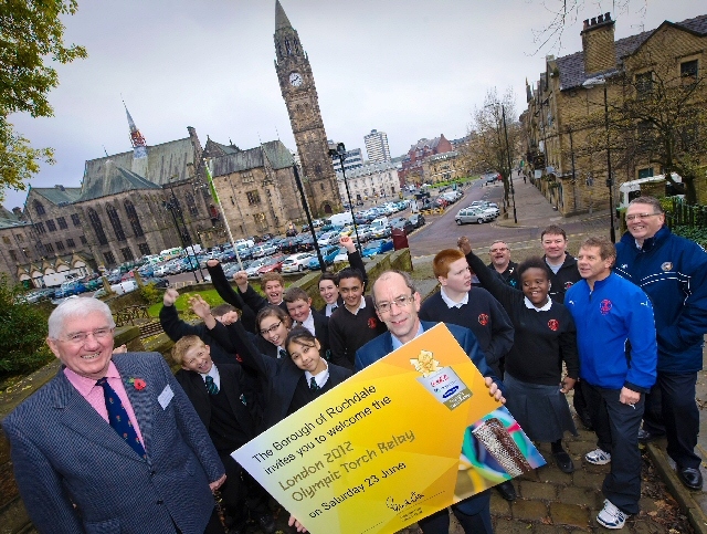 Chair of Link4Life Brian Ashworth (left), Council Leader Colin Lambert (centre) local school children and representatives from nearby sports clubs are delighted the London 2012 Olympic Torch will visit the borough during its journey next year.

 

