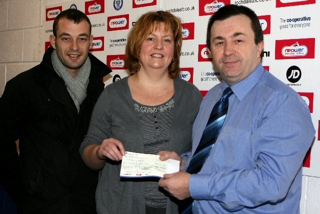 Dean Connaughton, Community Fundraiser for Springhill Hospice and Sarah Ford, Income Services Lead for Springhill Hospice receive the cheque from Chief Executive of Rochdale AFC, Colin Garlick.