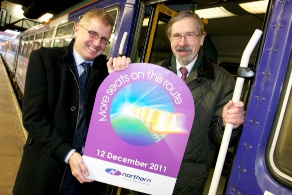 Ian Bevan, Managing Director of Northern Rail and Councillor Andrew Fender, Chairman of the Transport for Greater Manchester Committee, welcoming the 07.13 Leeds to Manchester Victoria service, arriving in at 08.53 with 111 additional seats