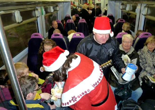 Mother Christmas handing out the last of the gifts whilst a member of Littleborough Public Brass Band collected for the band