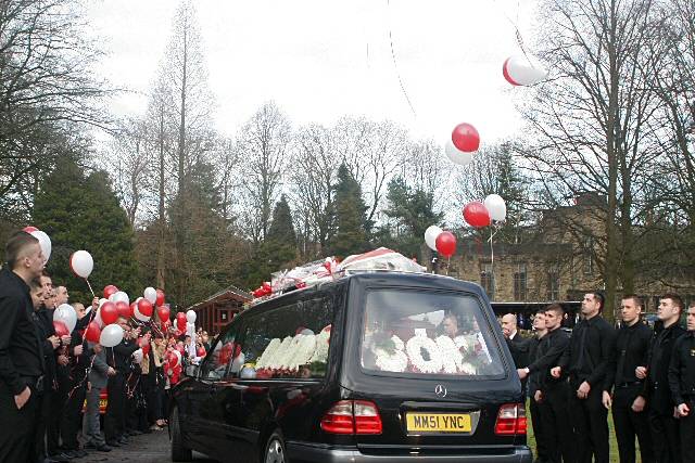 The friends of Danny Wilson let off red and white balloons as the funeral cortege passed through their guard of honour