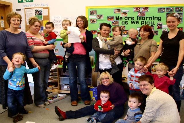 Parents and children at Derby Street Children’s Centre with a copy of their Outstanding Ofsted report