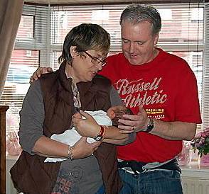 Corrine, seen here with grand-daughter Elsie-Mai and husband Jamie 
