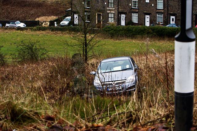 The driver of this car had a lucky escape after swerving on Huddersfield Road, Newhey, and down a steep bank

