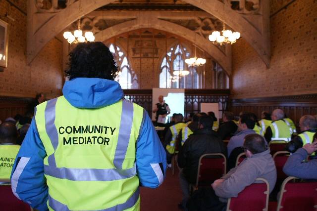 Faith and community leaders donned their high-visibility jackets marked with ‘Community Mediator’ on the back 