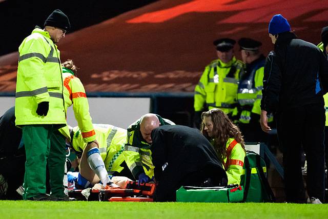 Huddersfield's Anthony Pilkington is treated for an horrific leg injury