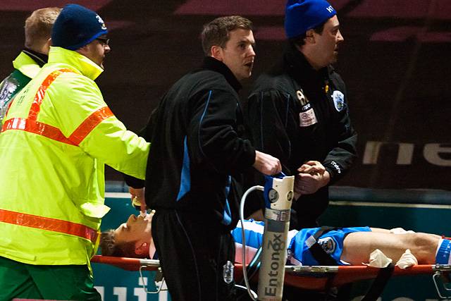 Huddersfield's Anthony Pilkington is stretched off after an horrific leg injury