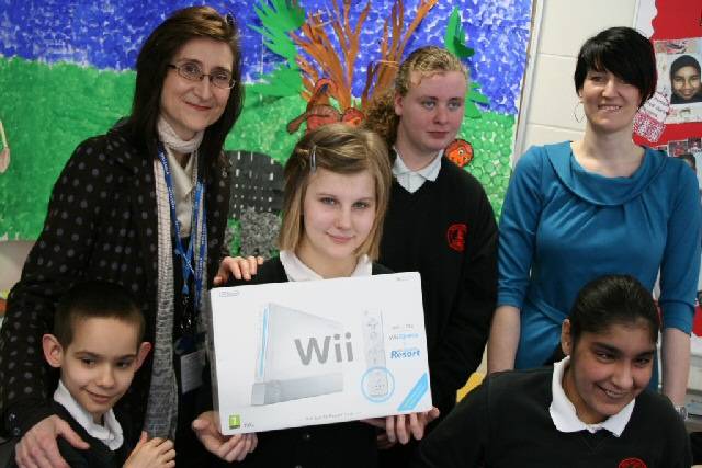 Jane Rossini, Director of Public Health (left) presents some of the pupils with their prize, with Samantha Doggett, Key Stage 4 Learning Mentor (right) at Redwood Secondary School in Rochdale