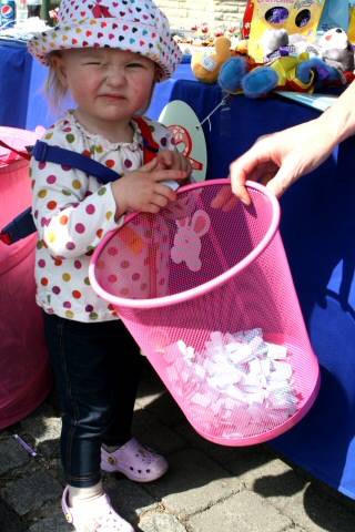 A toddler looking for a winning raffle ticket