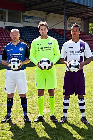 Gary Jones, Owain Fon Williams and Joe Thompson model Rochdale AFC's new home, goalkeeper's and away kits