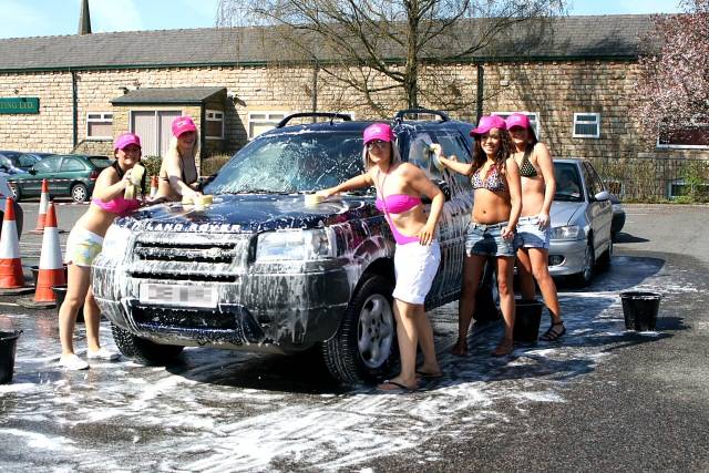 The ladies cleaning a car for charity