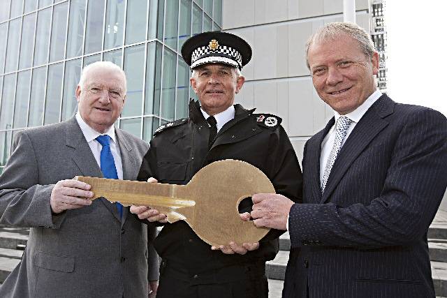 Developers Ask:Goodman present a ceremonial key to Councillor Paul Murphy of Greater Manchester Police Authority (GMPA) and Chief Constable Peter Fahy of GMP to signify completion of the construction