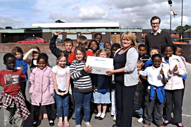 Community Support Officer Janice Alfrey hands over the Wii console to the children of Freehold