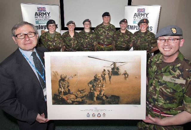 Colonel Kerry Trow, surrounded by the volunteers, presenting the print to Mr John Jesky 
