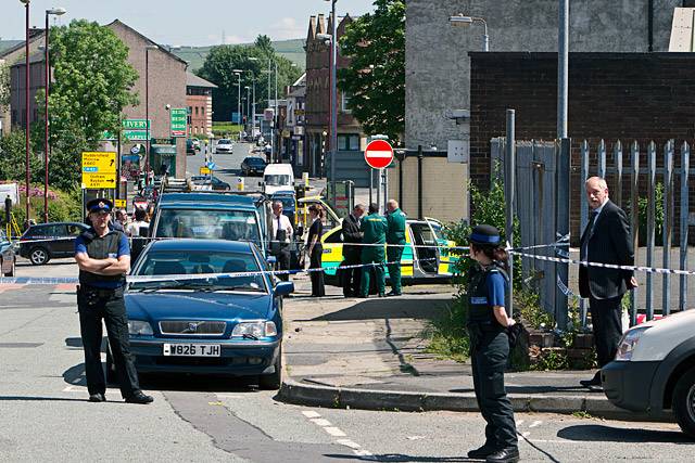 Police and paramedics at the scene of the disused building on School Lane, Rochdale