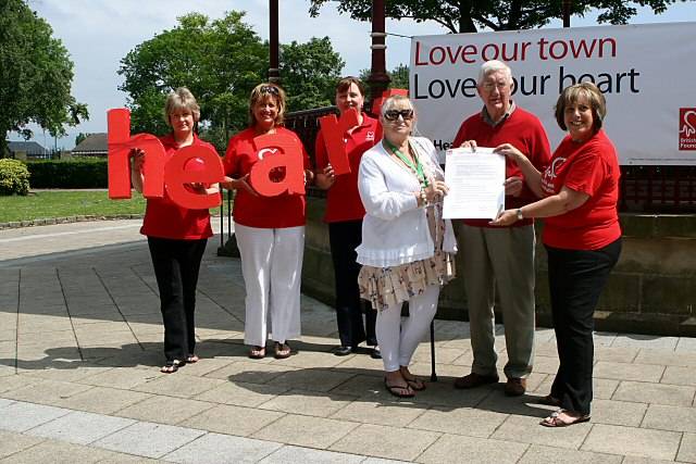 Councillor Linda Robinson, Brian Ashworth and Shirley McNally from the British Heart Foundation, sign the pledge