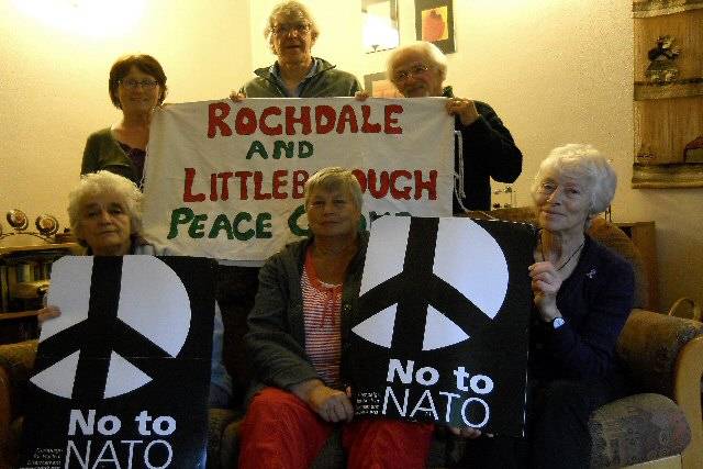 Peace Group members, George Abenstern, Mai Chatham, Patricia Gilligan, Philip Gilligan, Pat Sanchez, and Rae Street holding ‘No to NATO’ placards 