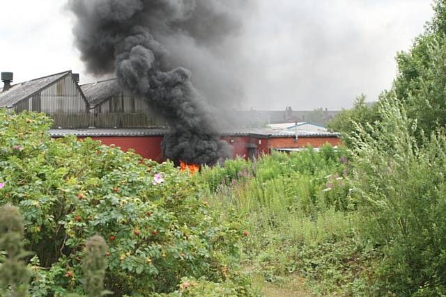 Old tyres piled up by the front door of the building and set alight