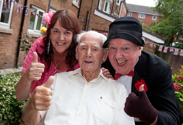 Scheme Manager Stella Watson and resident Mr Royle with Jimmy Cricket at the silver anniversary celebration

