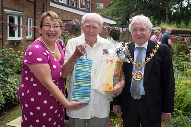 Guinness Northern Counties’ Chief Executive Carol Matthews and Mayor of Rochdale Councillor Alan Godson present Mr Royle with a token gift to celebrate 25 years at Roeacre Court sheltered housing scheme

