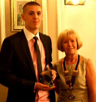 Jason Gregory accepting the award from Middleton Rotary Club president Janice Powell 