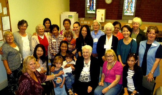 Mrs Vivien Carter, a deputy lieutenant of the Duchy of Lancaster (kneeling, front left) hands over a cheque for £600 to Mrs Margaret Spencer to boost the St Andrew's, Dearnley Wider Welcome fund, surrounded by members of the Littleborough International Women's Association.

