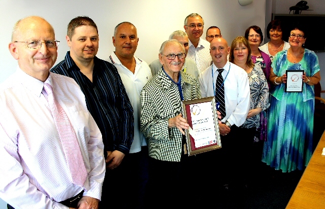 Volunteers accept their award: (left to right) Chairman John Schofield, Tony Wardle, Paul Gormley, Johnny Barlow, Jack Grimshaw, Colin McKinless, Jim Gosney, Michael Garside, Allison Byrne, Lillian Yates, Karen Byrne, Janet Hinkley.  
