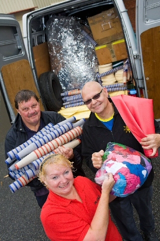 Members of the scrap stores swap their final items as they stand with a fully loaded van