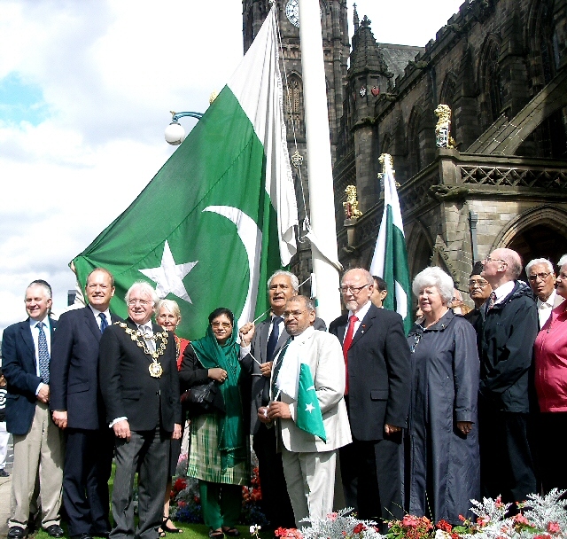 Dignitaries join with Ghulam Rasul Shahzad for the flag raising ceremony 
