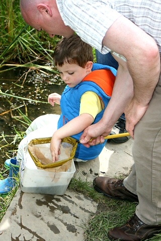 Daniel Rhodes empties his net into the water tub