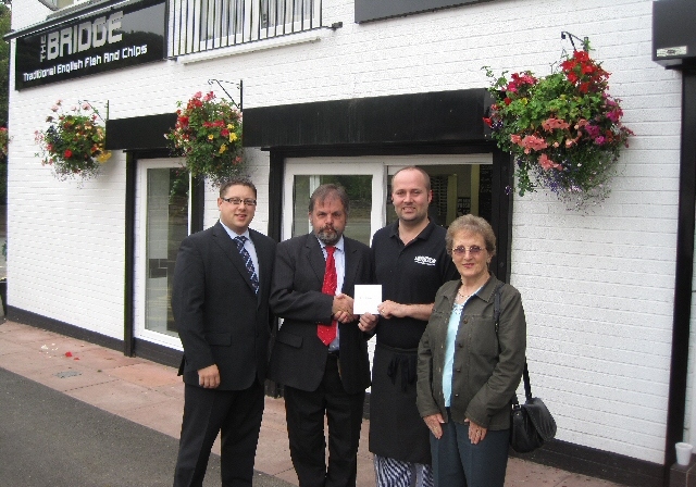 Chris, Manager at the Bridge Chippy receives their prize from Township in Bloom Steering Committee Chairman, Nigel Morell and Committee Members Peter Winkler and Kath Sharp