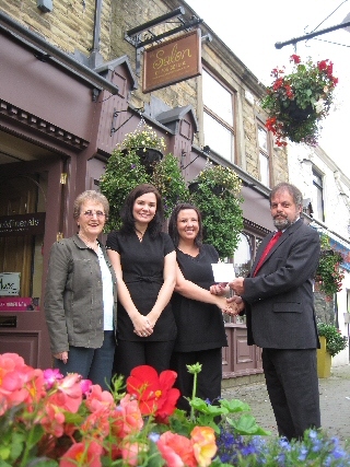 Staff from the Salon on Edenfield Road receive their prize from Township in Bloom Steering Committee Chairman, Nigel Morell and Committee Member / NEEVA Secretary Kath Sharp.