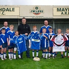 The team recieving their sponsored kit as well as a signed Salford City reds shirt as a prize from Matt Gilks